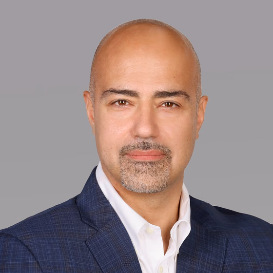 Samer Jalloul, founder of SJ Ventures, in a navy suit jacket and white shirt